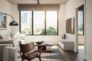 Modern living room with large city view window and minimalist decor Bright living room with city skyline view, contemporary furniture, and natural light.